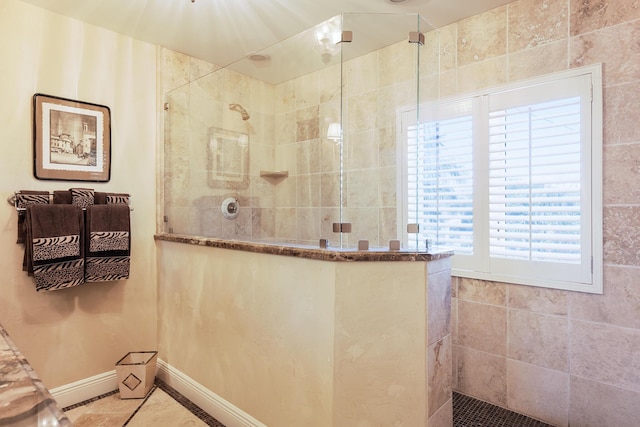 full bath featuring walk in shower and tile patterned flooring