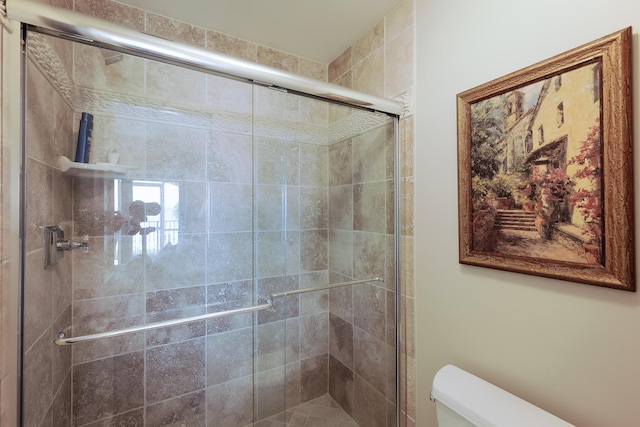 full bathroom with toilet and a stall shower