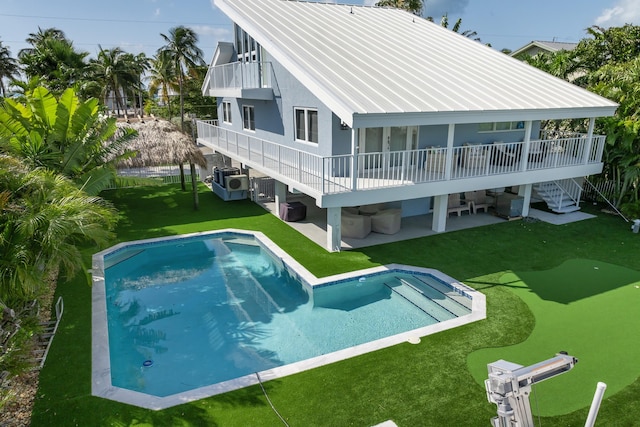 rear view of house featuring an outdoor living space, a lawn, an outdoor pool, stairway, and a patio