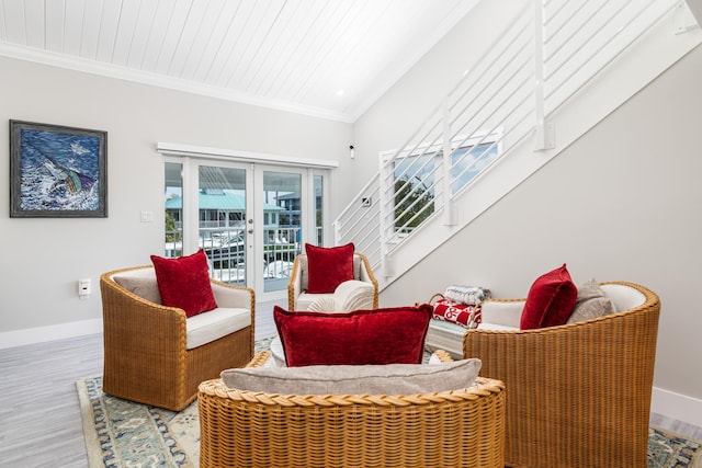 sitting room featuring baseboards, ornamental molding, french doors, and wood finished floors