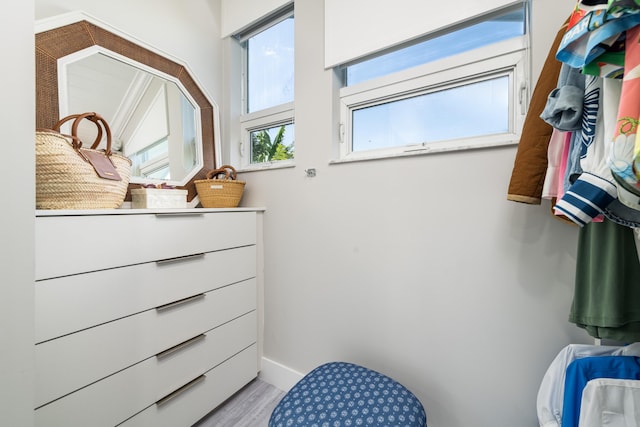 bathroom with baseboards and wood finished floors