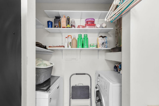 clothes washing area with washing machine and dryer