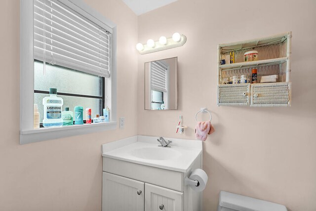 bathroom featuring toilet and vanity