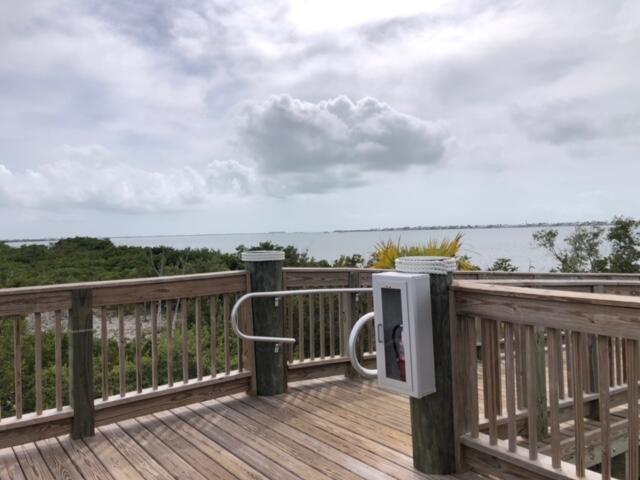 231 Pelican Ln, Big Pine, FL 33043 - wooden terrace with a water view