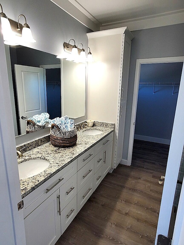 231 Pelican Ln, Big Pine, FL 33043 - bathroom with a spacious closet, wood finished floors, a sink, and double vanity