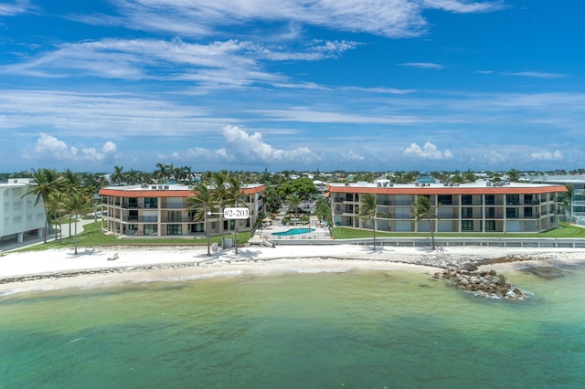 drone / aerial view featuring a water view and a view of the beach