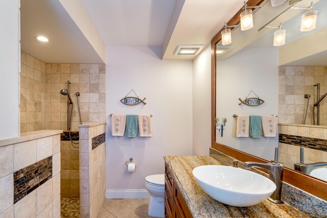 bathroom with vanity, visible vents, toilet, walk in shower, and tile patterned floors