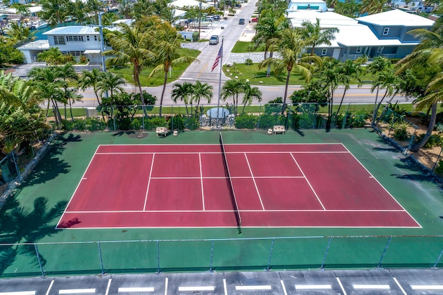 view of tennis court featuring fence