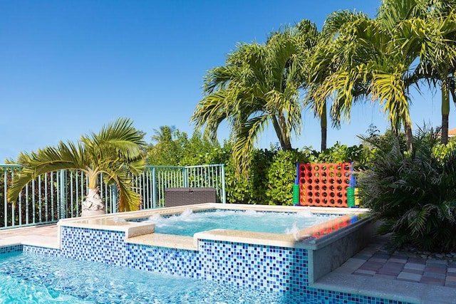 view of swimming pool featuring an in ground hot tub