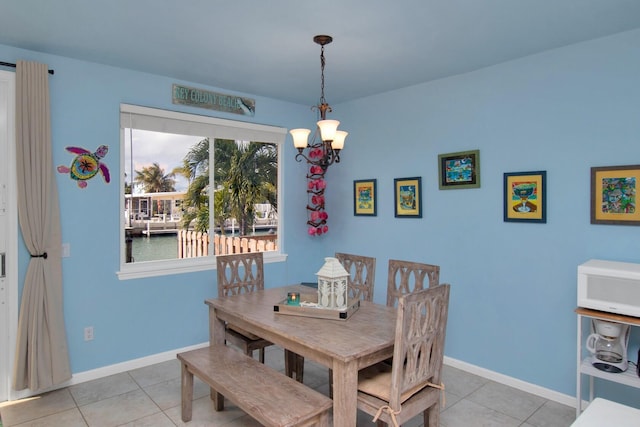 461 3rd St, Key Colony, FL 33051 - dining room with light tile patterned floors, a chandelier, and baseboards