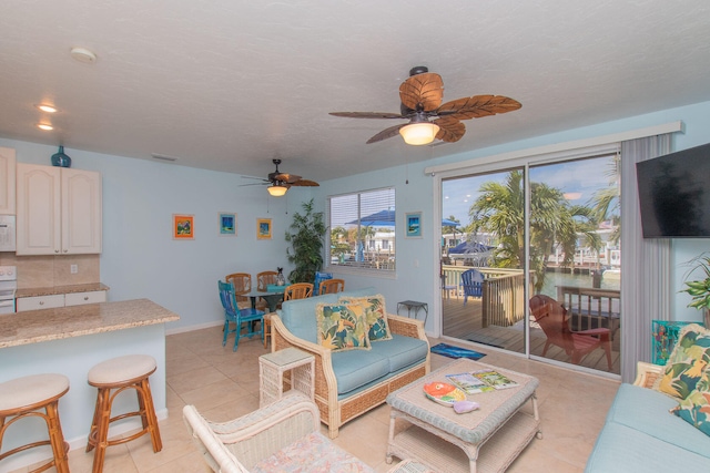 461 3rd St, Key Colony, FL 33051 - living room with a ceiling fan, light tile patterned flooring, and baseboards