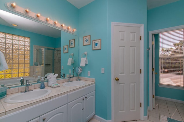461 3rd St, Key Colony, FL 33051 - bathroom featuring a stall shower, tile patterned flooring, double vanity, and plenty of natural light