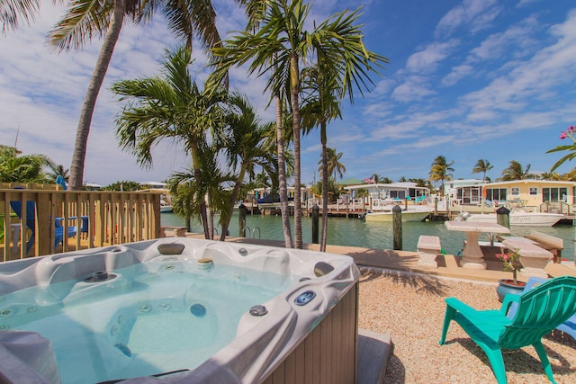461 3rd St, Key Colony, FL 33051 - view of patio / terrace featuring a water view, a hot tub, and a boat dock