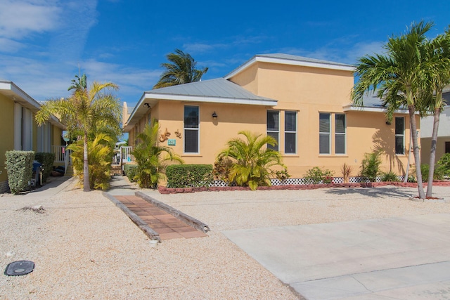 461 3rd St, Key Colony, FL 33051 - view of front of property with stucco siding and metal roof