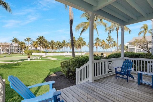 wooden deck featuring a yard