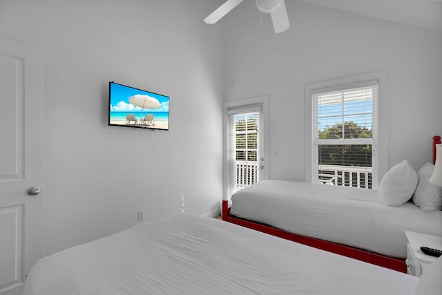 bedroom with access to outside, vaulted ceiling, and ceiling fan