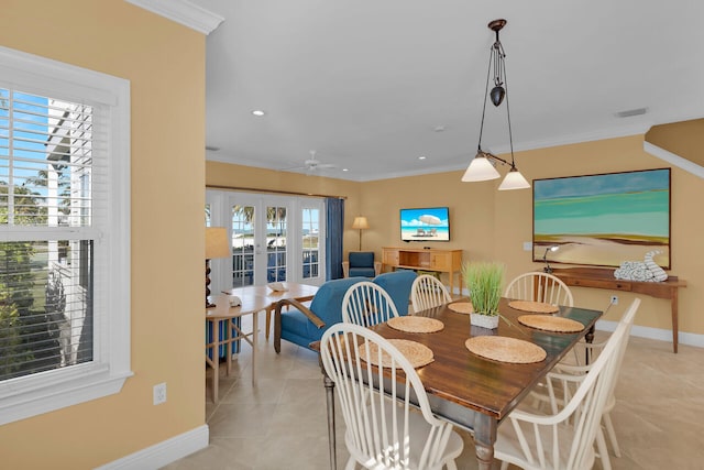 dining space with light tile patterned floors, french doors, and ornamental molding