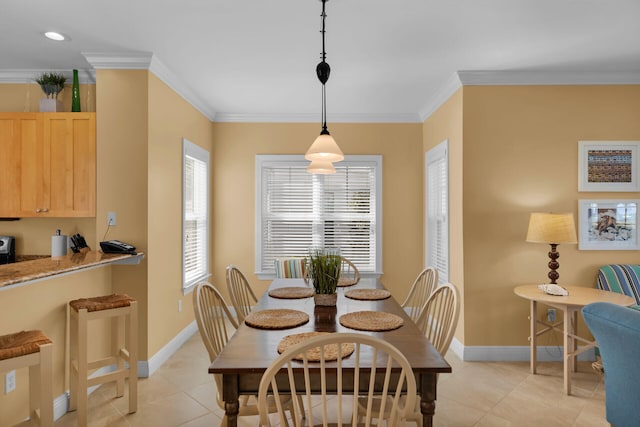 dining room with a wealth of natural light, crown molding, and light tile patterned floors