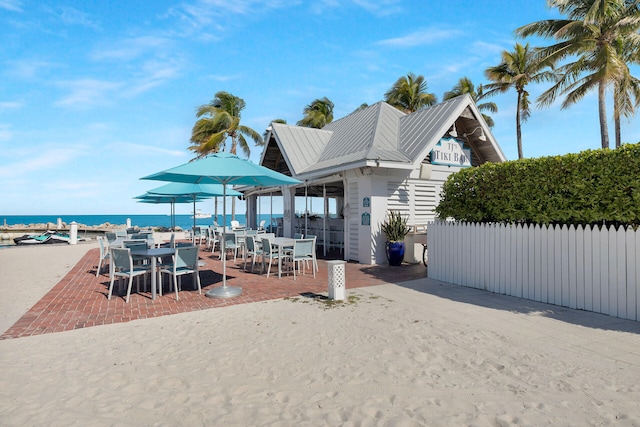 exterior space featuring a water view and fence