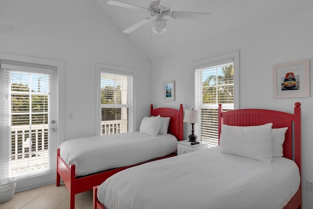 bedroom with access to outside, multiple windows, vaulted ceiling, and light tile patterned floors