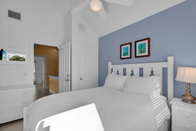 bedroom featuring lofted ceiling, ceiling fan, light tile patterned floors, and visible vents