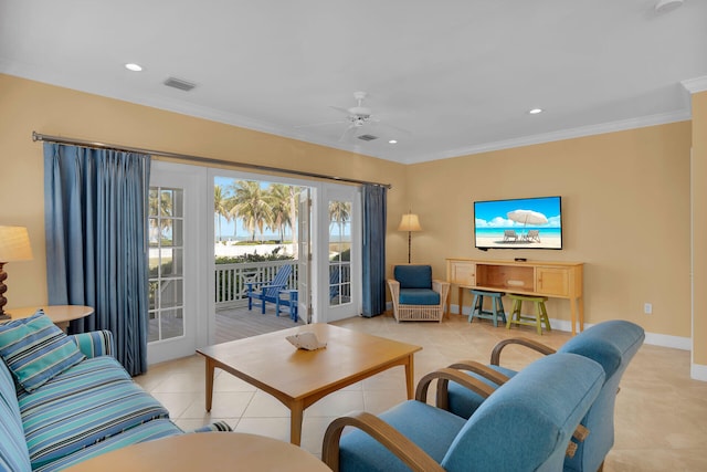 living room with crown molding, light tile patterned floors, visible vents, ceiling fan, and baseboards