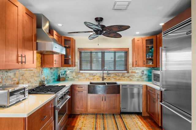1613 Bahama Dr, Key West, FL 33040 - kitchen featuring high end appliances, wall chimney exhaust hood, a sink, ceiling fan, and light countertops