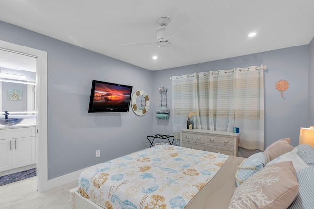 bedroom with ensuite bath, baseboards, a sink, and recessed lighting