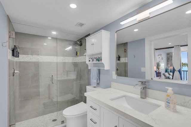 full bathroom featuring visible vents, a stall shower, vanity, and toilet