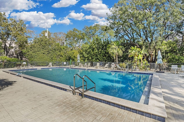 pool featuring a patio area and fence