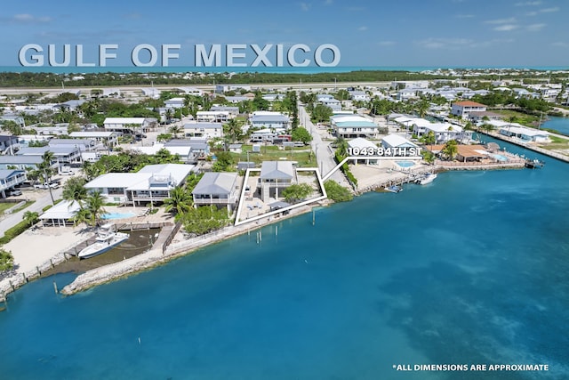 drone / aerial view with a residential view and a water view