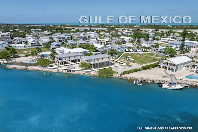 drone / aerial view featuring a residential view and a water view