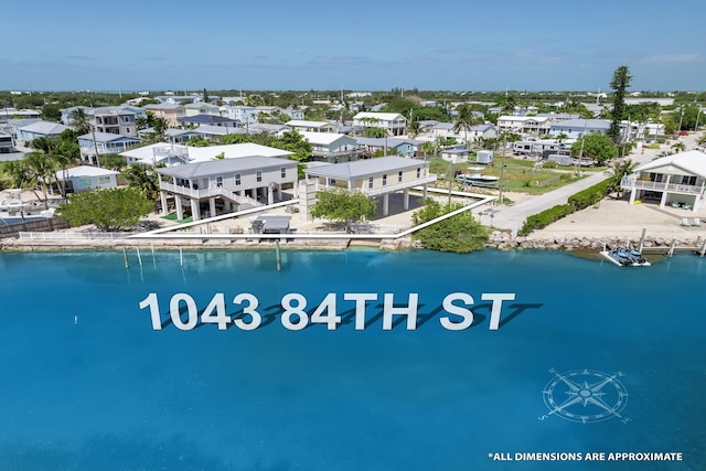 birds eye view of property featuring a residential view and a water view