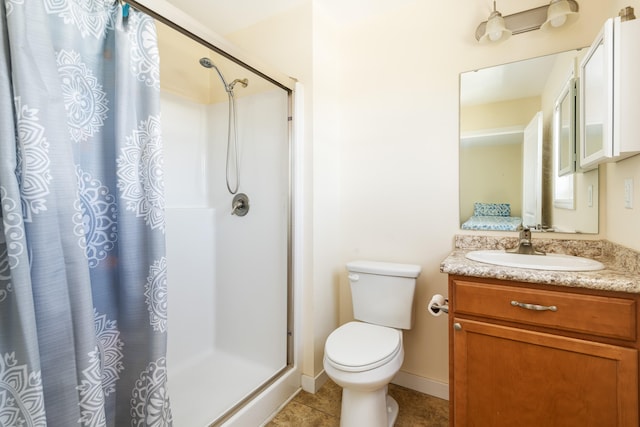 bathroom featuring tile patterned floors, toilet, a shower with shower curtain, baseboards, and vanity