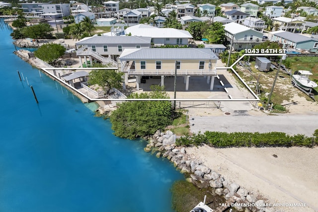 drone / aerial view with a residential view and a water view