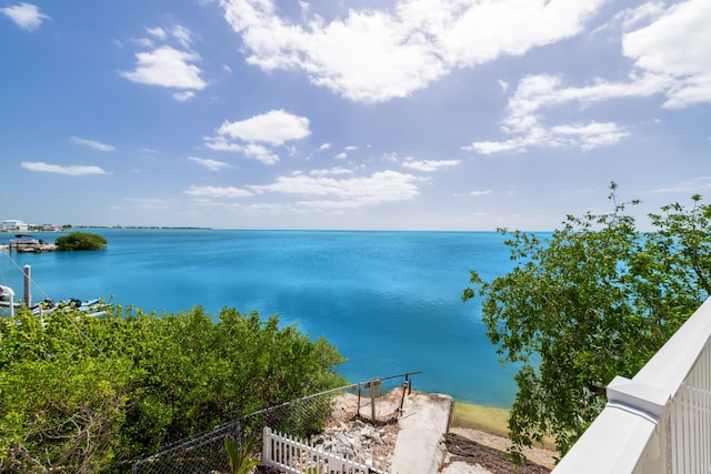 property view of water featuring fence