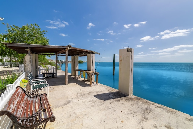 view of patio / terrace with a gazebo, a carport, and a water view