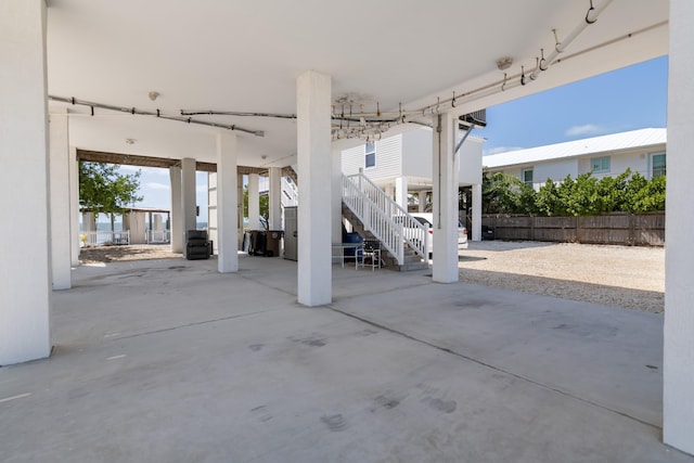 view of patio featuring stairs and fence