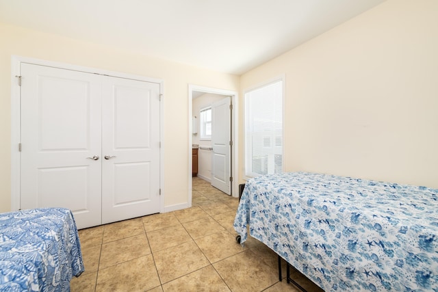 bedroom featuring a closet and light tile patterned flooring