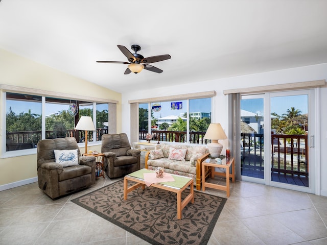 living room featuring tile patterned floors, baseboards, lofted ceiling, and ceiling fan