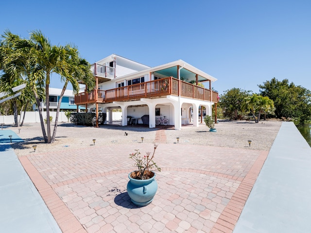 back of property featuring a patio area and fence