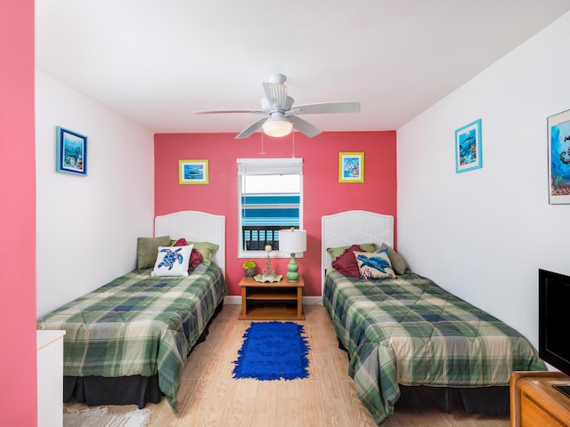 bedroom with wood finished floors and a ceiling fan