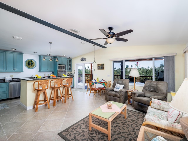 living room featuring light tile patterned floors, visible vents, ceiling fan, and vaulted ceiling