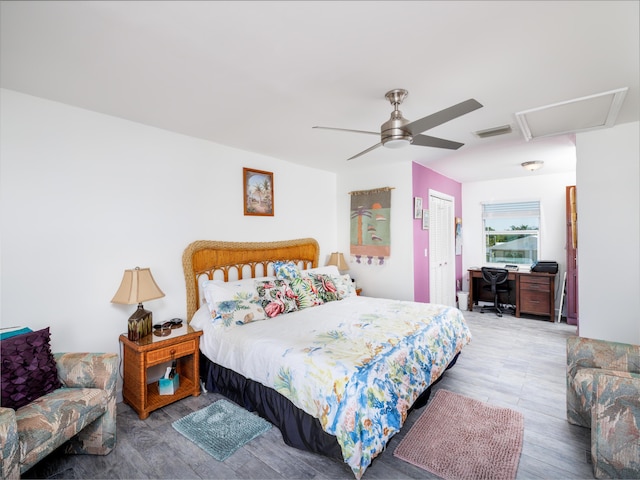 bedroom featuring visible vents, a closet, wood finished floors, and a ceiling fan