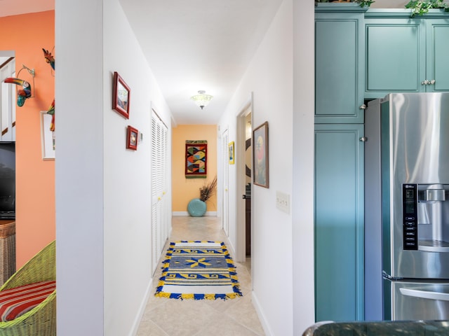 hall with tile patterned flooring and baseboards