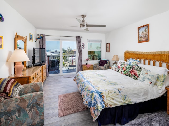 bedroom with access to exterior, a ceiling fan, and wood finished floors