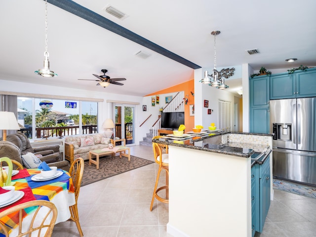 kitchen featuring blue cabinets, visible vents, stainless steel fridge with ice dispenser, and light tile patterned floors