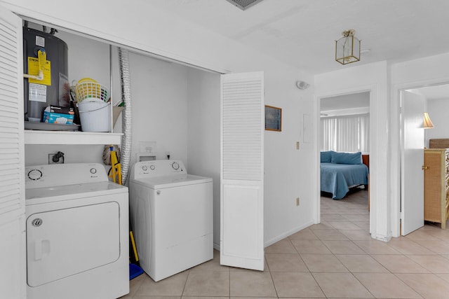 5019THST & St, Key Colony, FL 33051 - washroom with separate washer and dryer, light tile patterned flooring, water heater, and baseboards