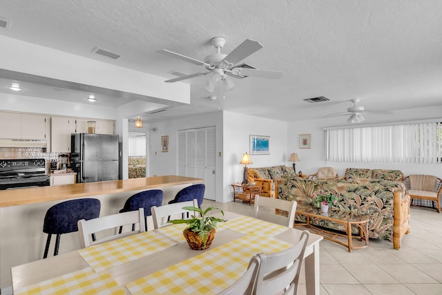 5019THST & St, Key Colony, FL 33051 - dining space with ceiling fan, light tile patterned floors, and a textured ceiling
