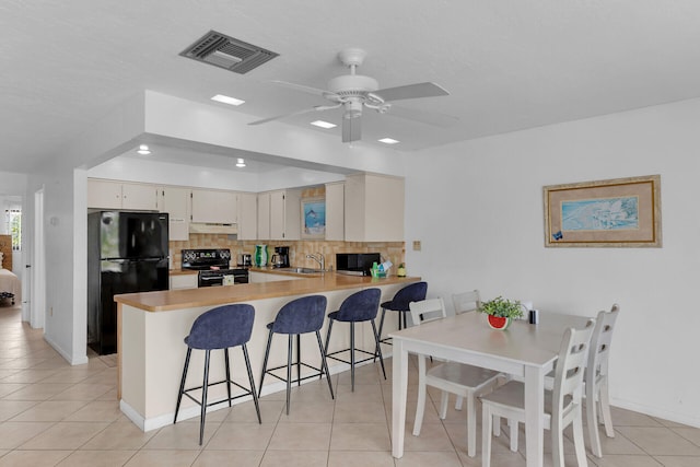 5019THST & St, Key Colony, FL 33051 - kitchen featuring black appliances, a sink, light tile patterned floors, backsplash, and under cabinet range hood